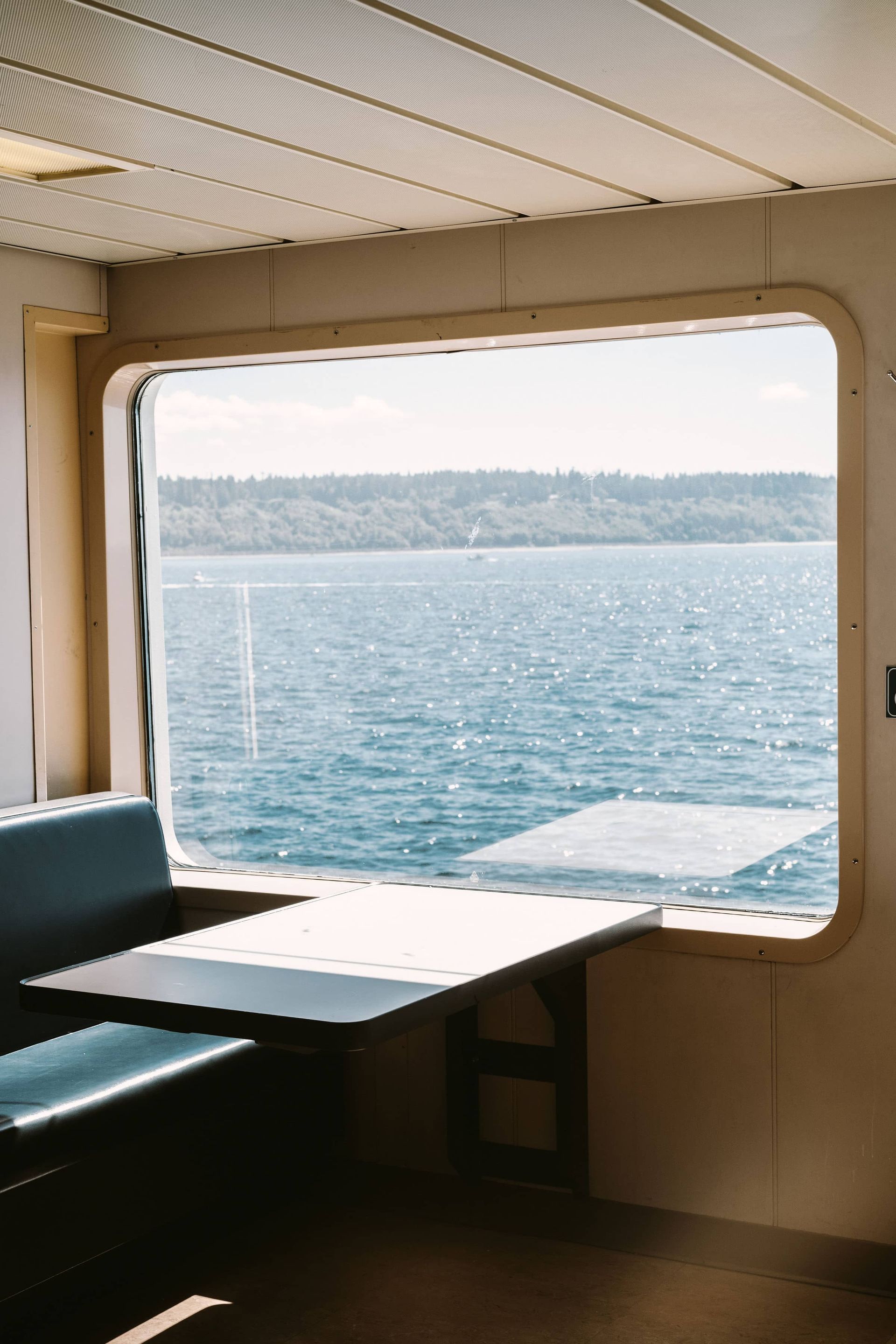 There is a large window with a view of the ocean.