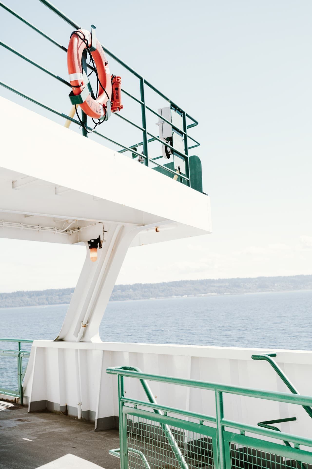 A life preserver is hanging from the railing of a boat