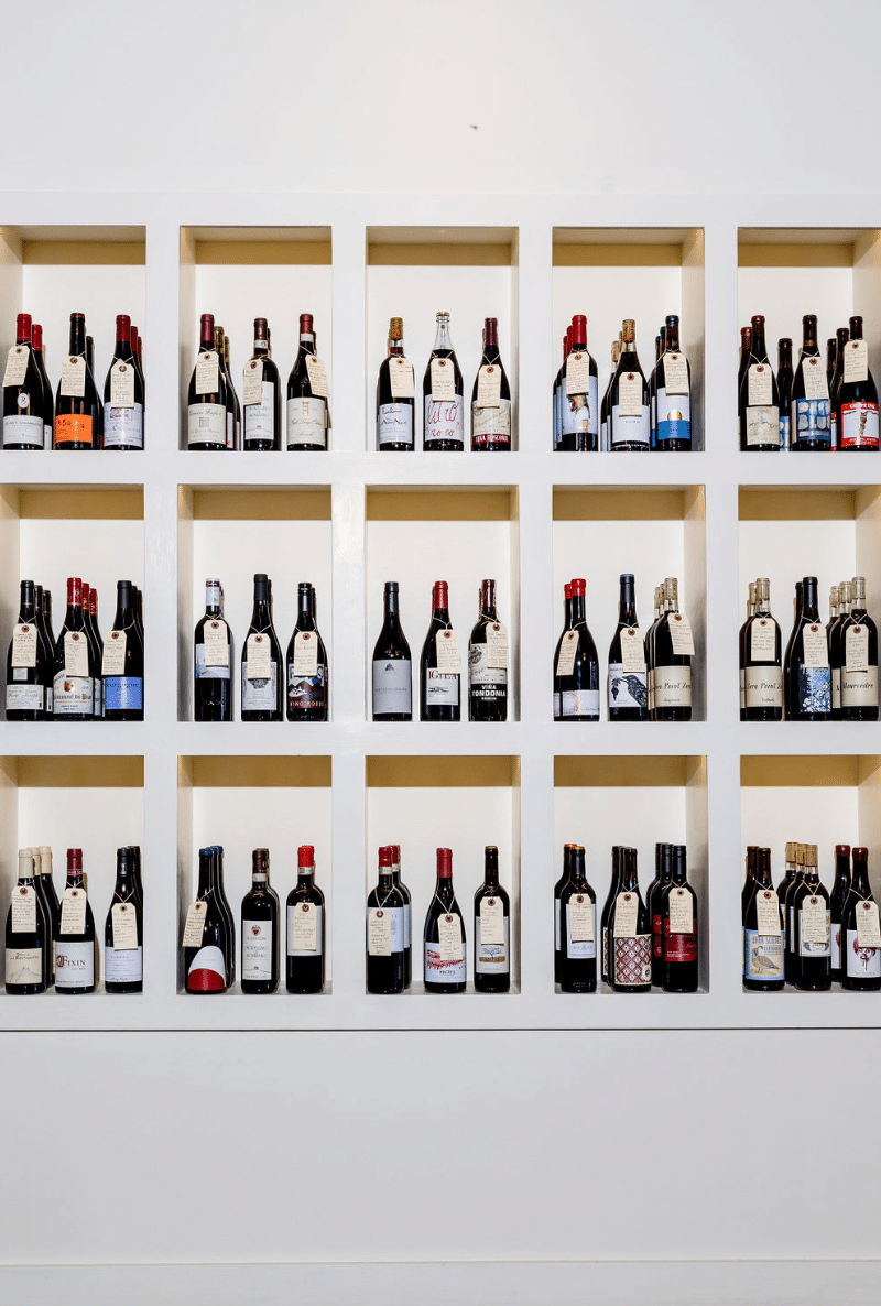 A wall filled with lots of bottles of wine