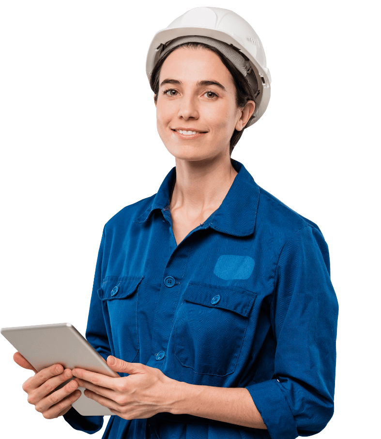 Woman in blue jumpsuit and white hard hat, holding tablet, smiling.