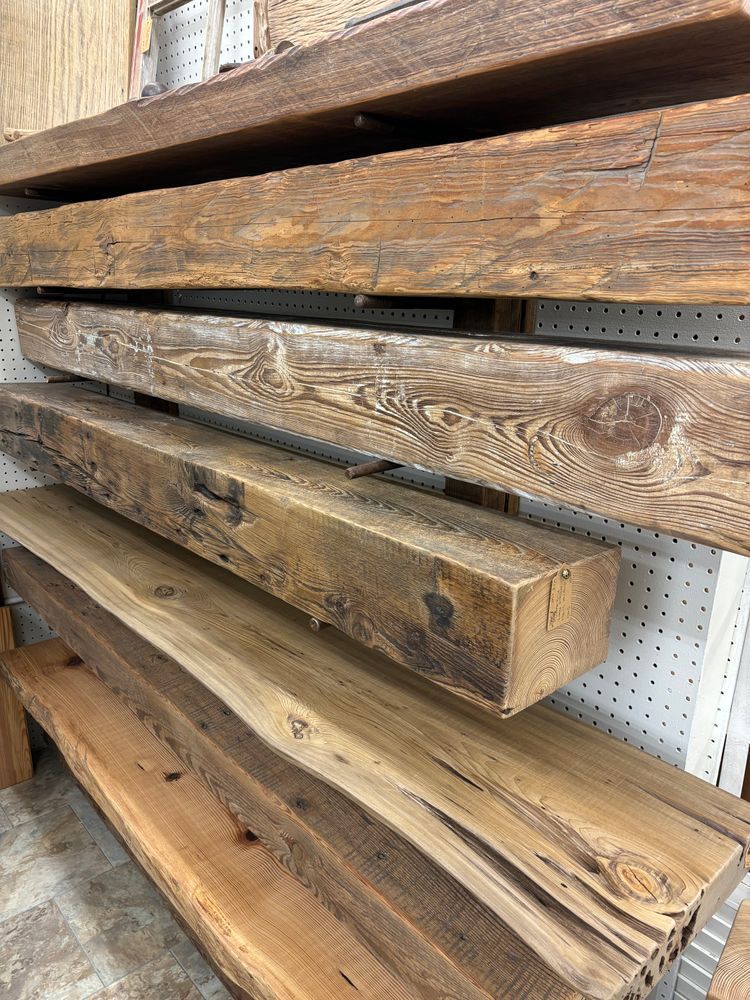 A bunch of wooden beams are stacked on top of each other on a shelf.