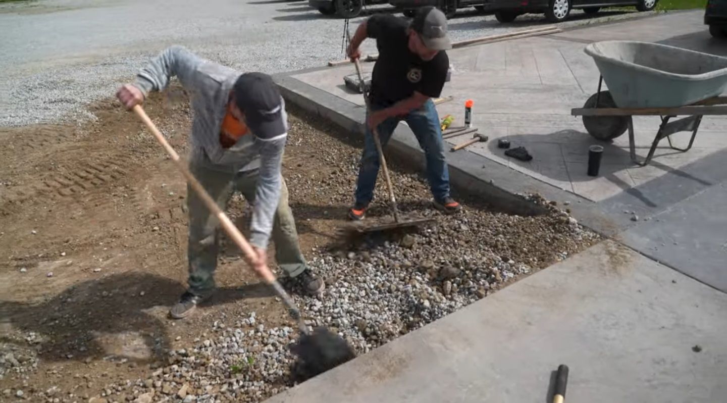 An image of two guys prepping for a concrete driveway pour.