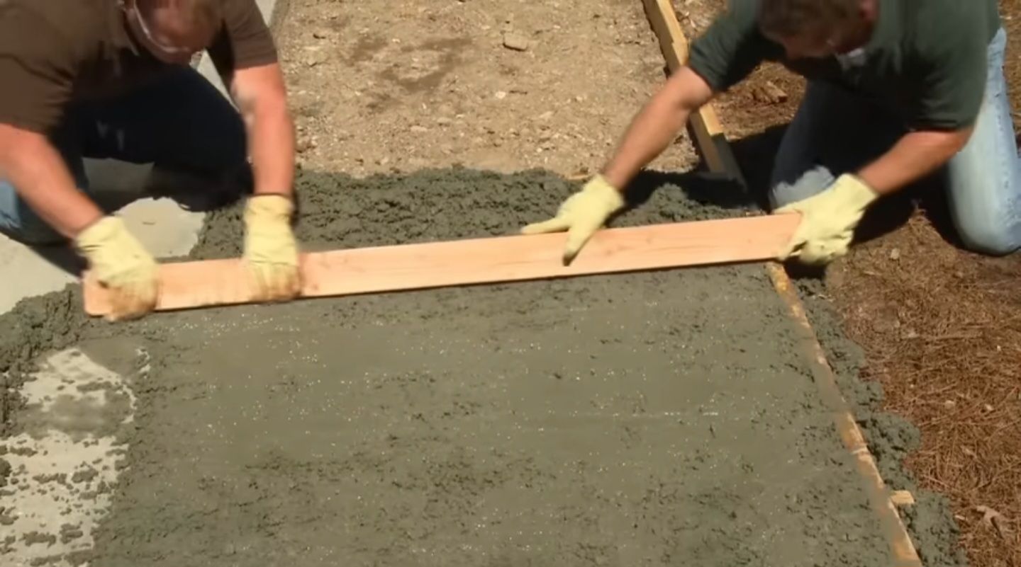 An image of a concrete pathway being leveled.