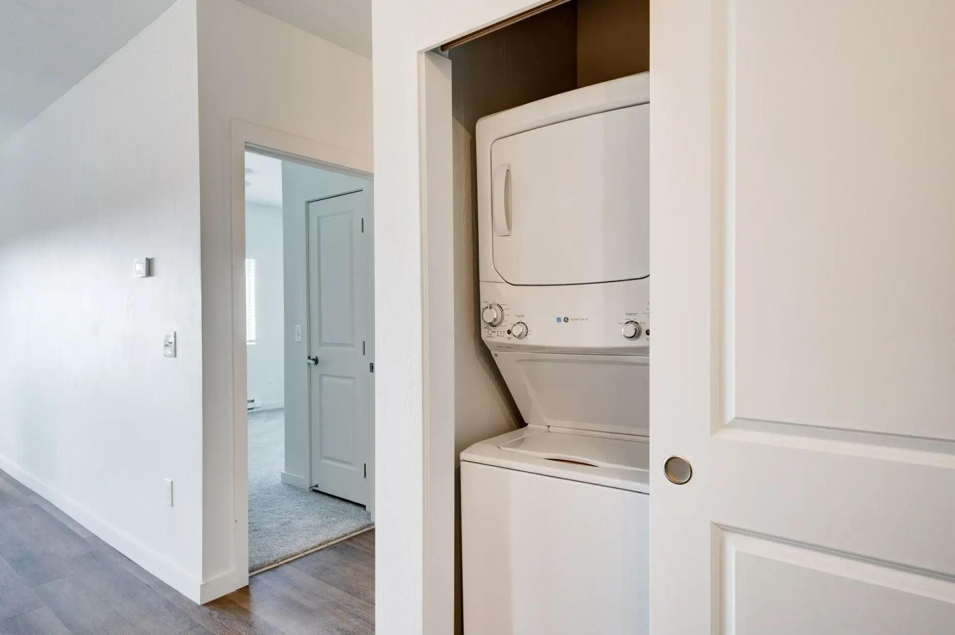 Stacked washer and dryer in a compact laundry closet.