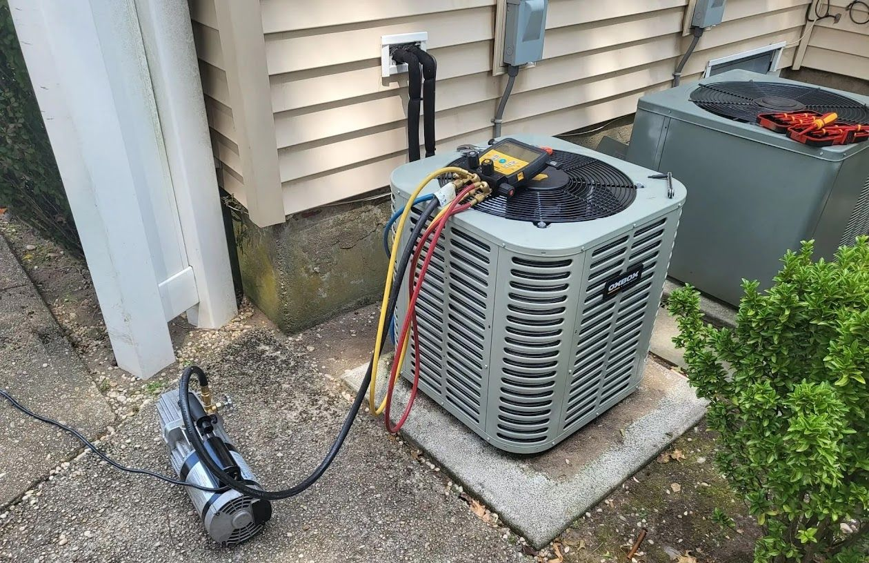 HVAC technician in a hard hat, repairs an air conditioning unit outdoors.