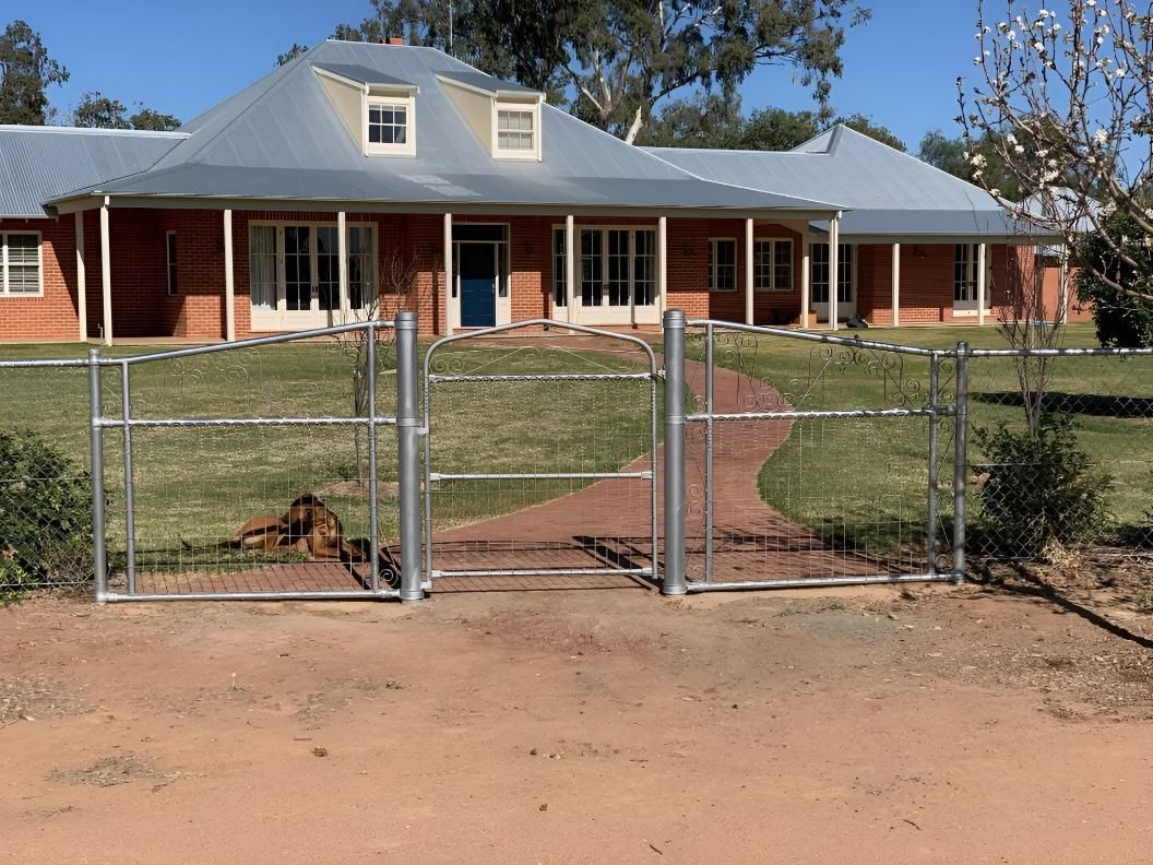 A Large Brick House with A Metal Fence in Front of It — Ballimore Welding in Ballimore, NSW