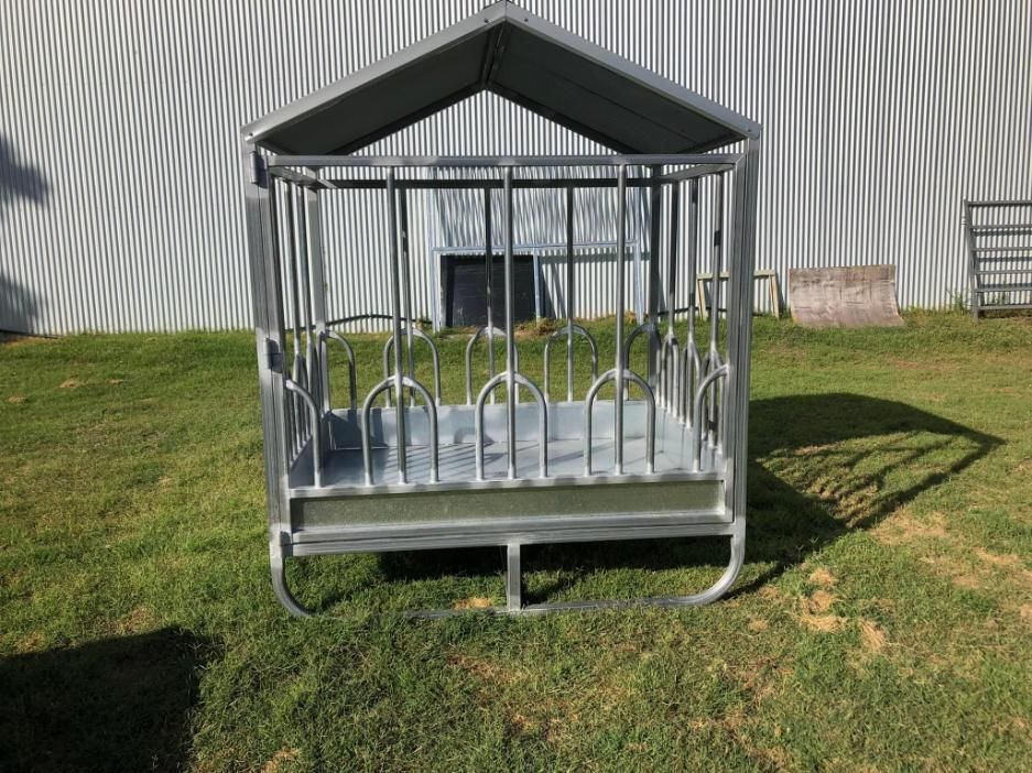 A Hay Feeder with A Canopy Is Sitting in The Grass in Front of A Building — Ballimore Welding in Scone, NSW