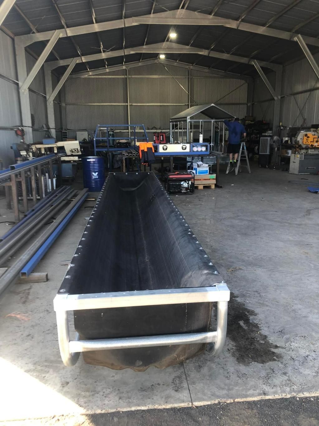 A Large Metal Pipe Is Sitting in The Middle of A Warehouse — Ballimore Welding in Scone, NSW
