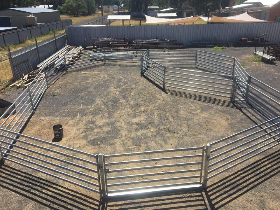 A Large Metal Fence Is Surrounding a Dirt Field — Ballimore Welding in Ballimore, NSW