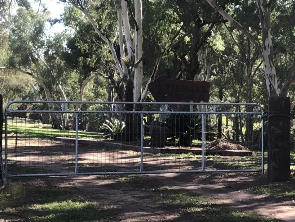 A Metal Gate Is Surrounded by Trees and Grass — Ballimore Welding in Ballimore, NSW