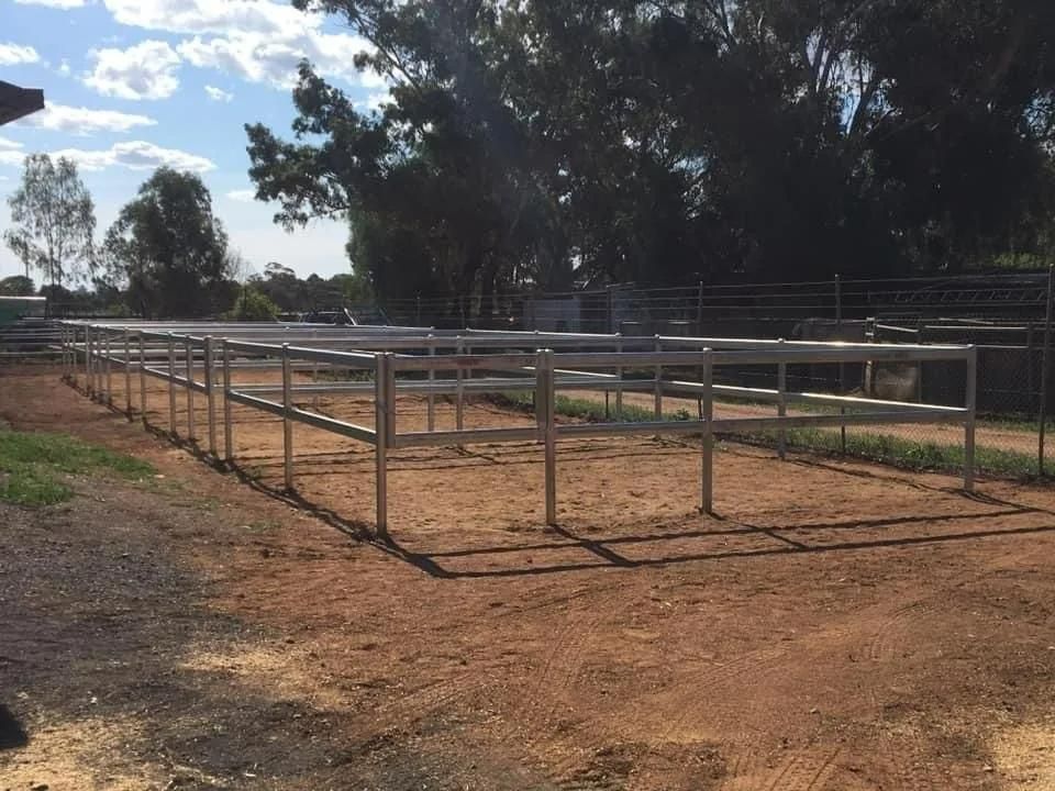 A Fence Is Surrounding a Dirt Field with Trees in The Background — Ballimore Welding in Ballimore, NSW