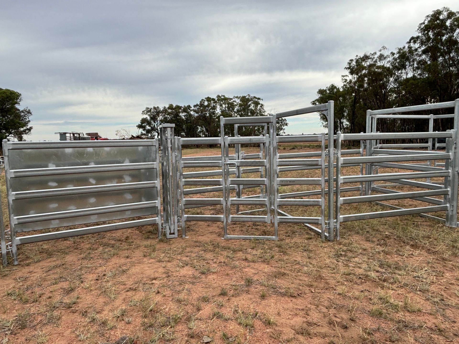 Galvanized steel stadium seating frames stacked outdoors.