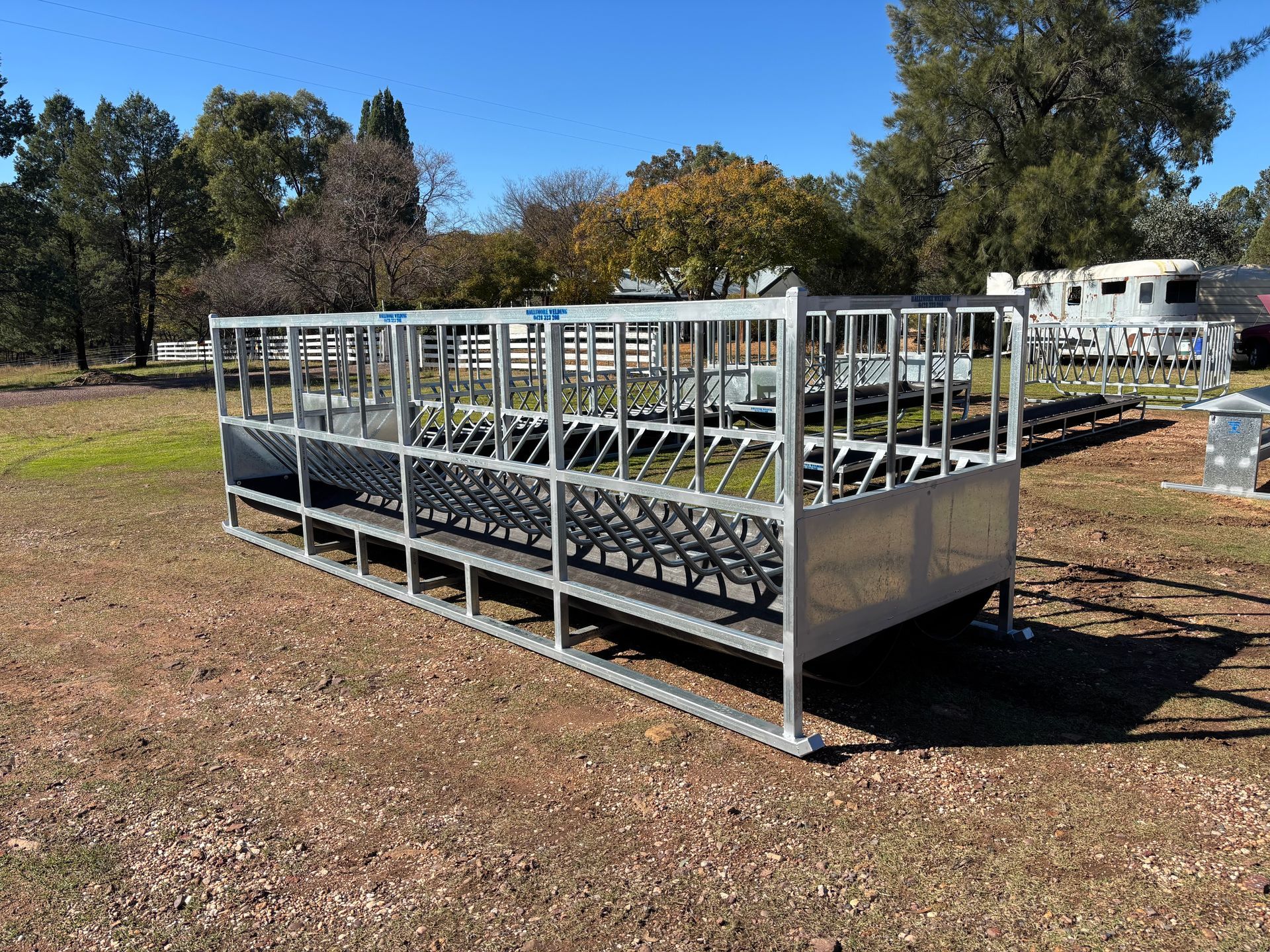 A Herd of Cows Are Eating Hay from A Feeder — Ballimore Welding in Ballimore, NSW