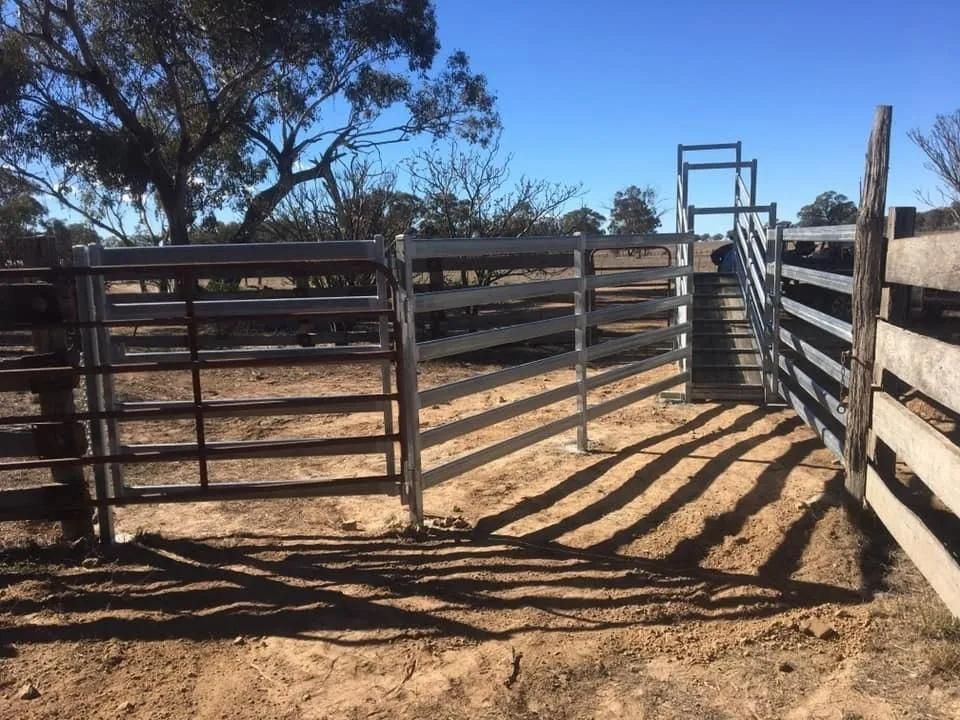 A Fence with A Gate in The Middle of A Dirt Field — Ballimore Welding in Ballimore, NSW