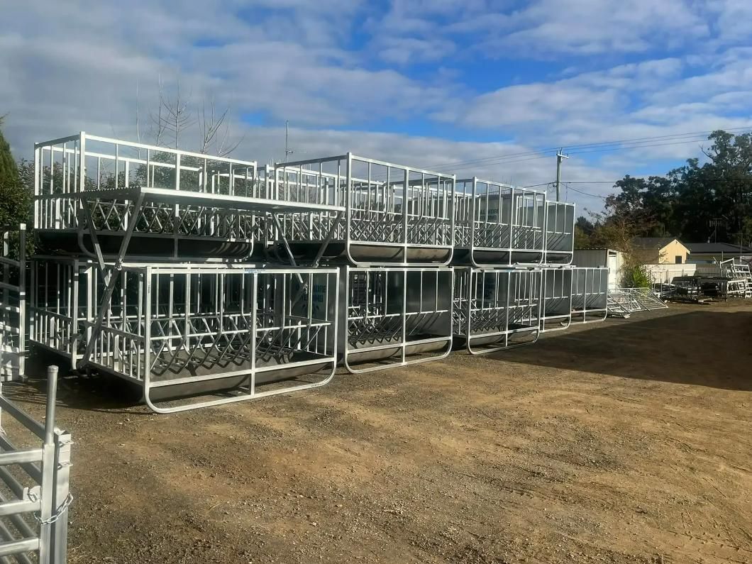 A Row of Metal Crates Are Sitting on Top of Each Other in A Dirt Field — Ballimore Welding in Ballimore, NSW