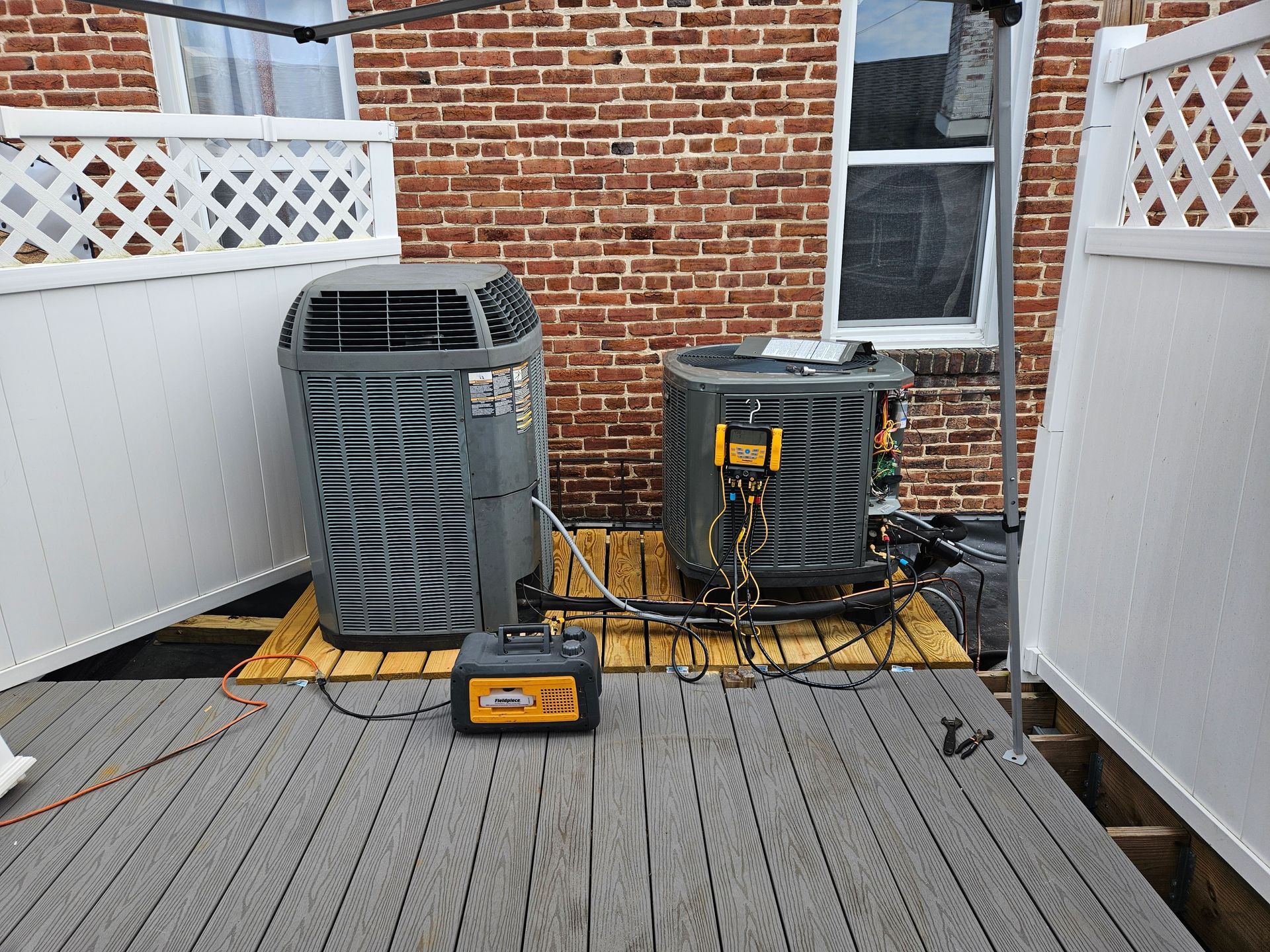 A large machine is sitting on top of a white box in a room.