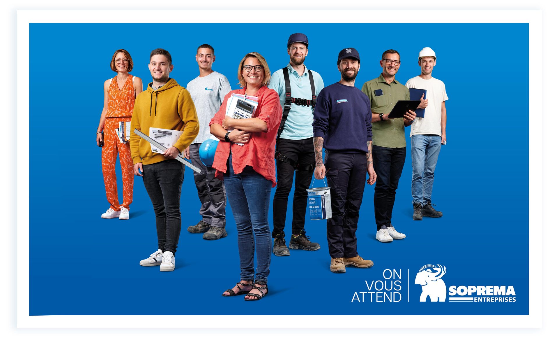 Groupe de professionnels de tous horizons, souriants, en tenue de travail, sur fond bleu. Soprema