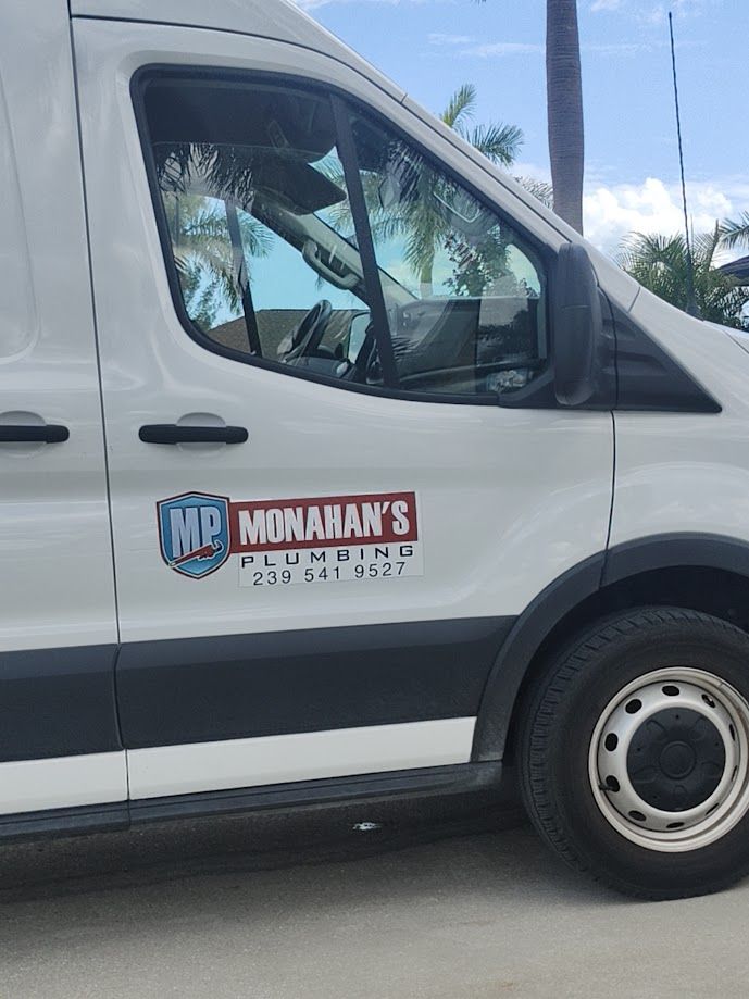 White van parked in front of a large house; the van has 