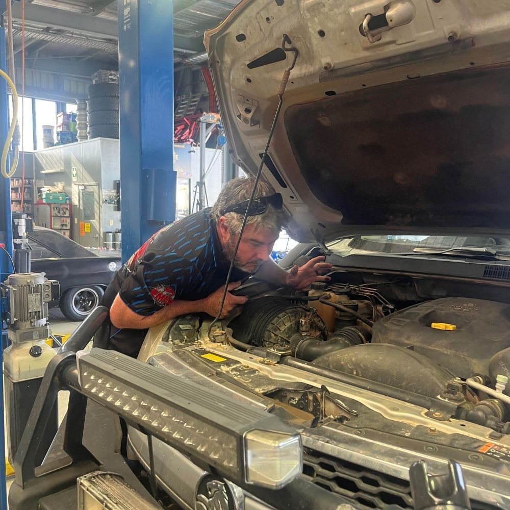 Mechanic checking car engine