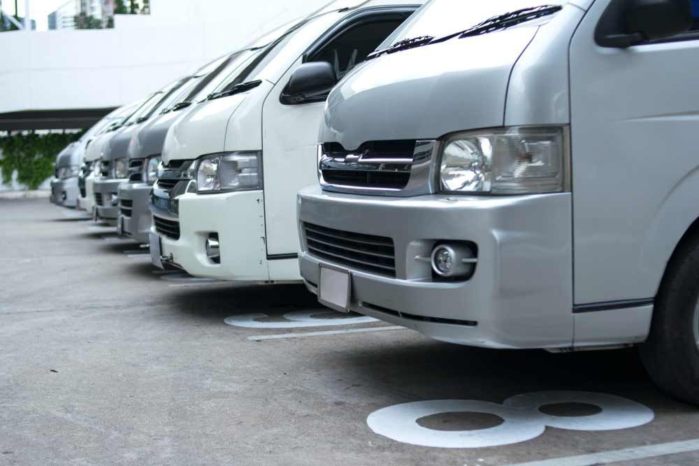 A Row Of Vans Are Parked In A Parking Lot — MB Automotive In Garbutt, QLD