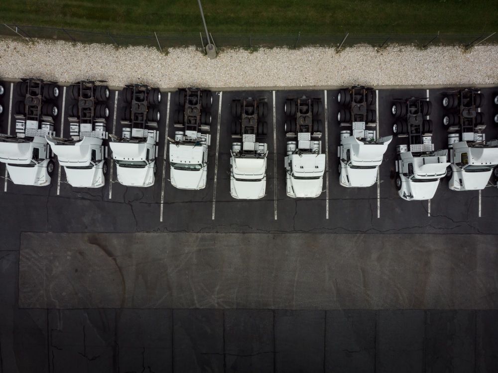 A Row Of White Trucks Are Parked In A Parking Lot — MB Automotive In Garbutt, QLD