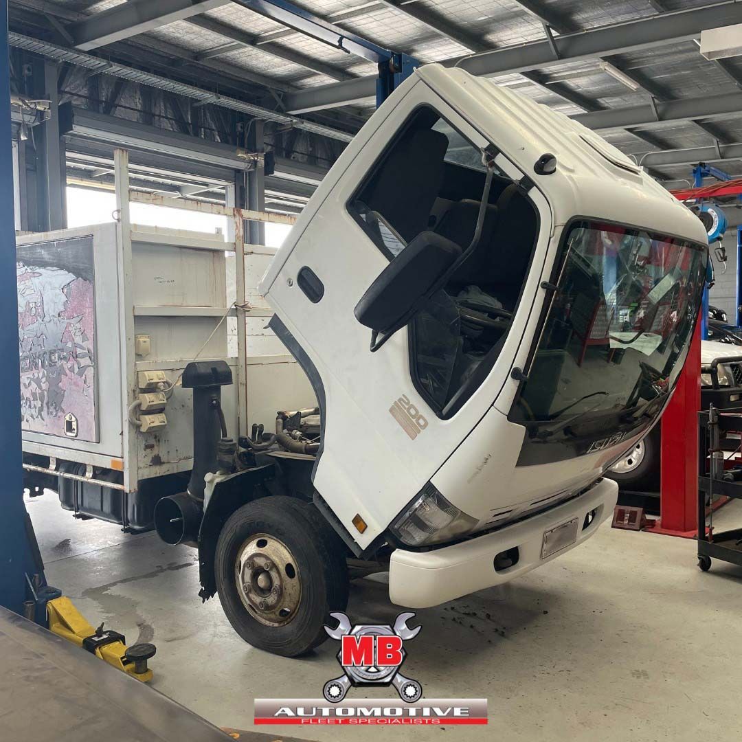 A White Truck With The Hood Up Is In A Garage — MB Automotive In Garbutt, QLD