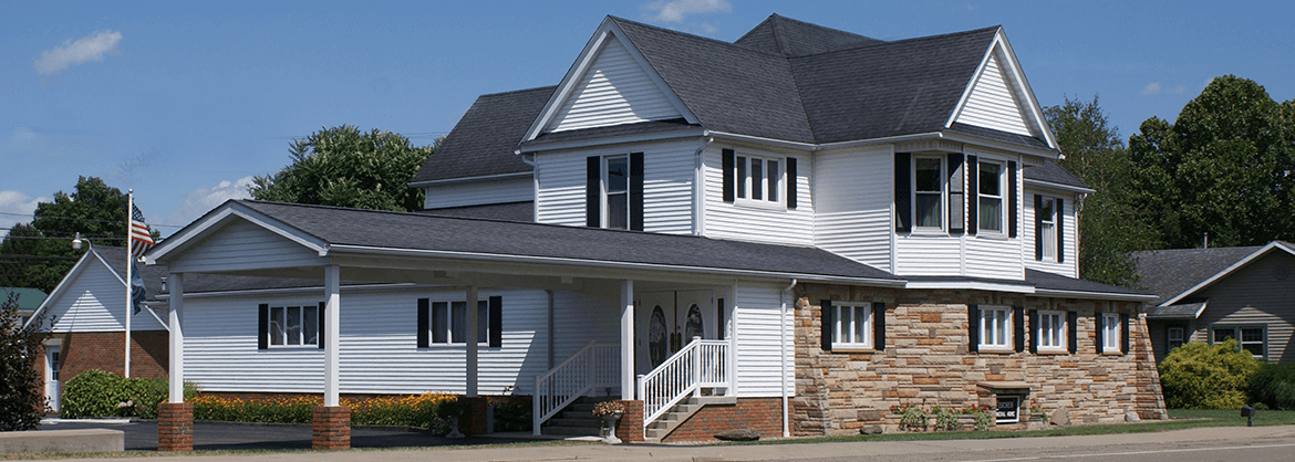 A large white house with a gray roof
