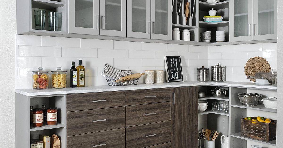 Kitchen with white countertops and cabinets, with dark wood lower cabinets and shelves.