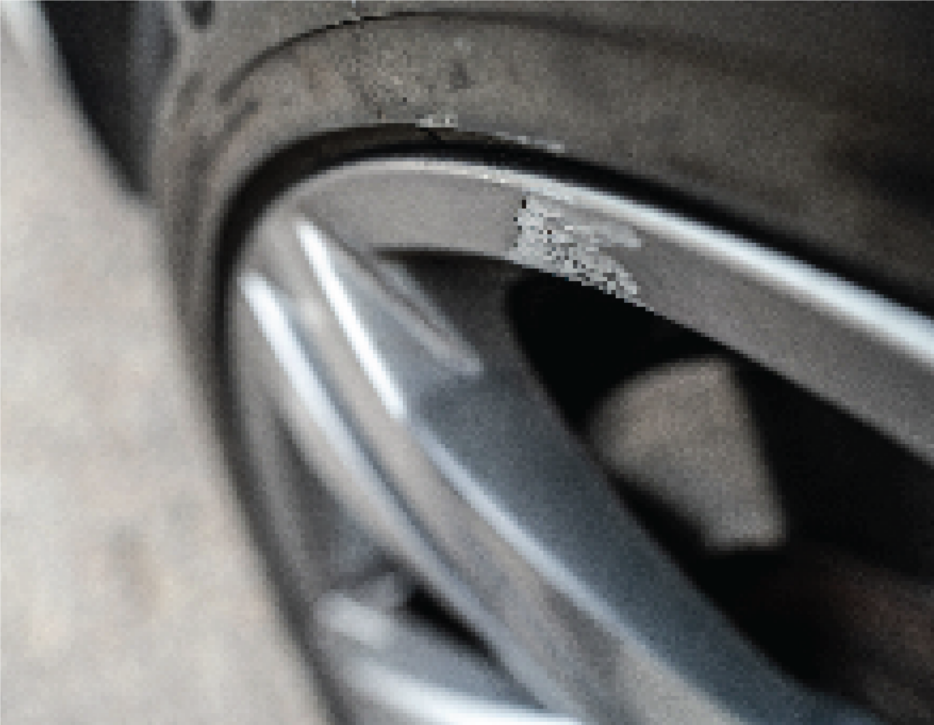 A person is working on a car wheel in a garage.