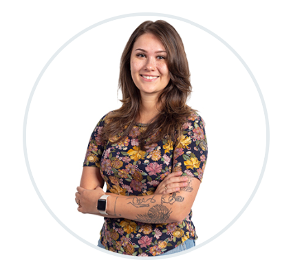 a woman with a tattoo on her arm is standing in a circle with her arms crossed .