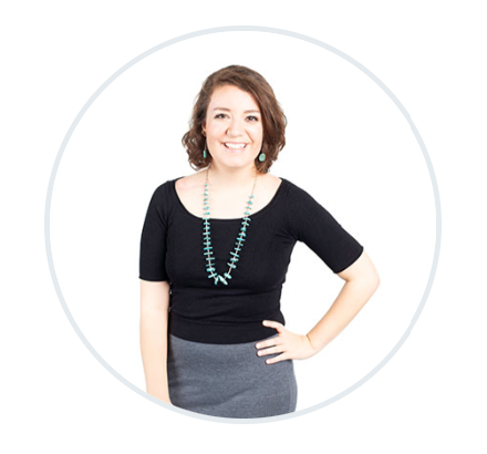 a woman wearing a black top and a grey skirt