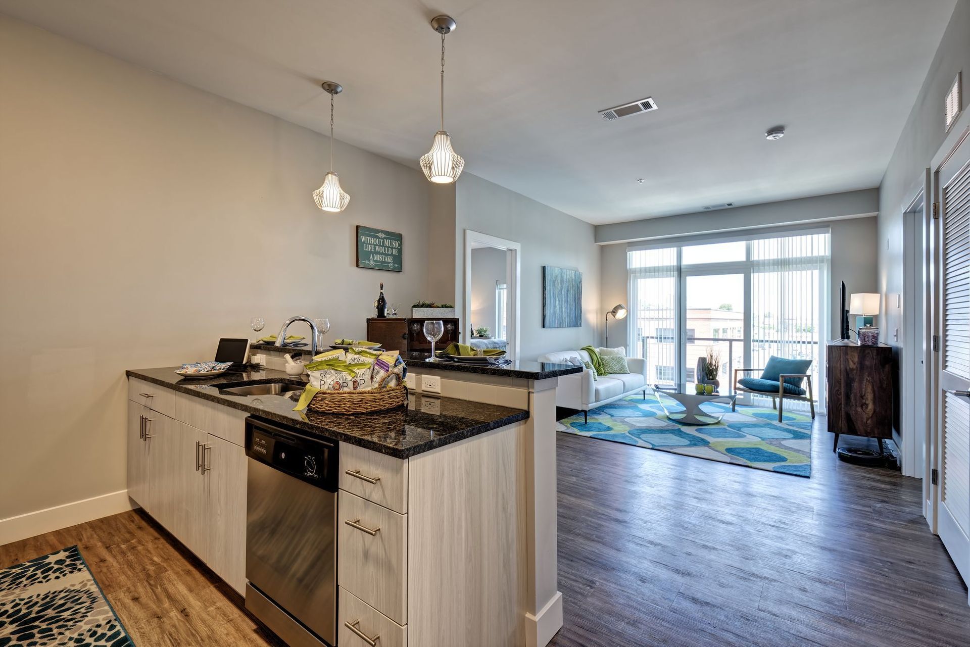 A kitchen with stainless steel appliances and wooden floors