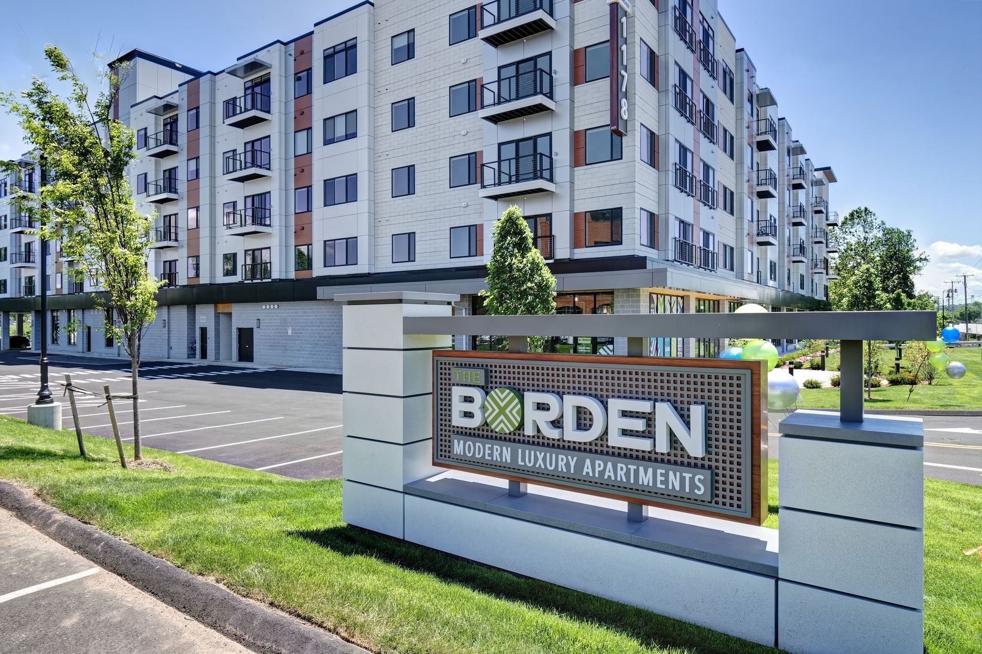A large apartment building with a sign in front of it that says borden