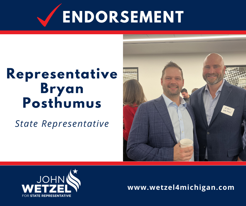 Two men are standing next to each other in a room.