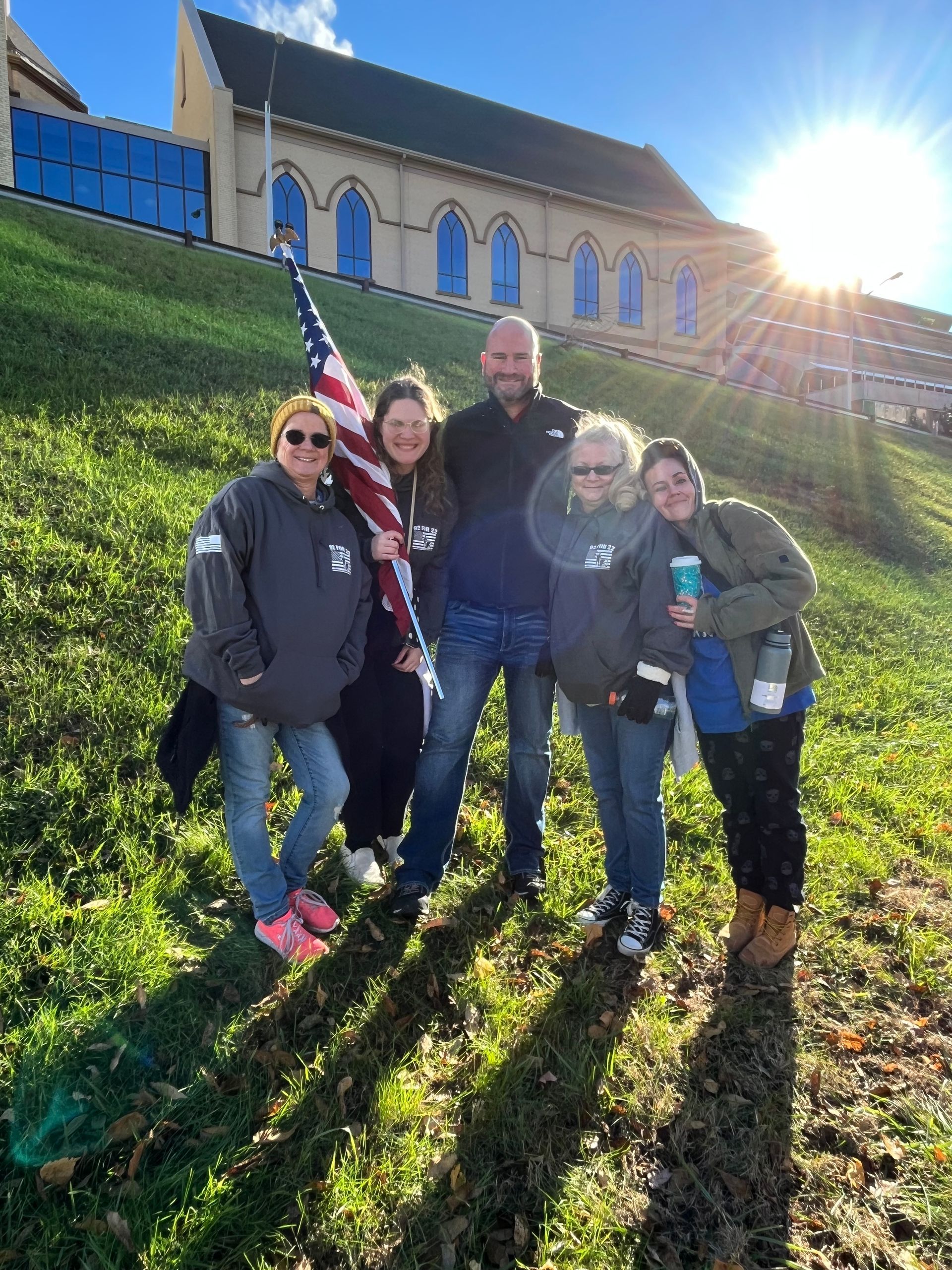 A group of people are posing for a picture in front of a church.
