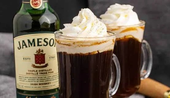 Coffee frappe with whipped cream, caramel drizzle, and a coffee bean.