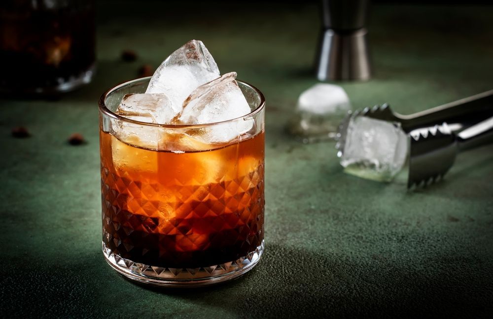 Coffee frappe with whipped cream, caramel drizzle, and a coffee bean.