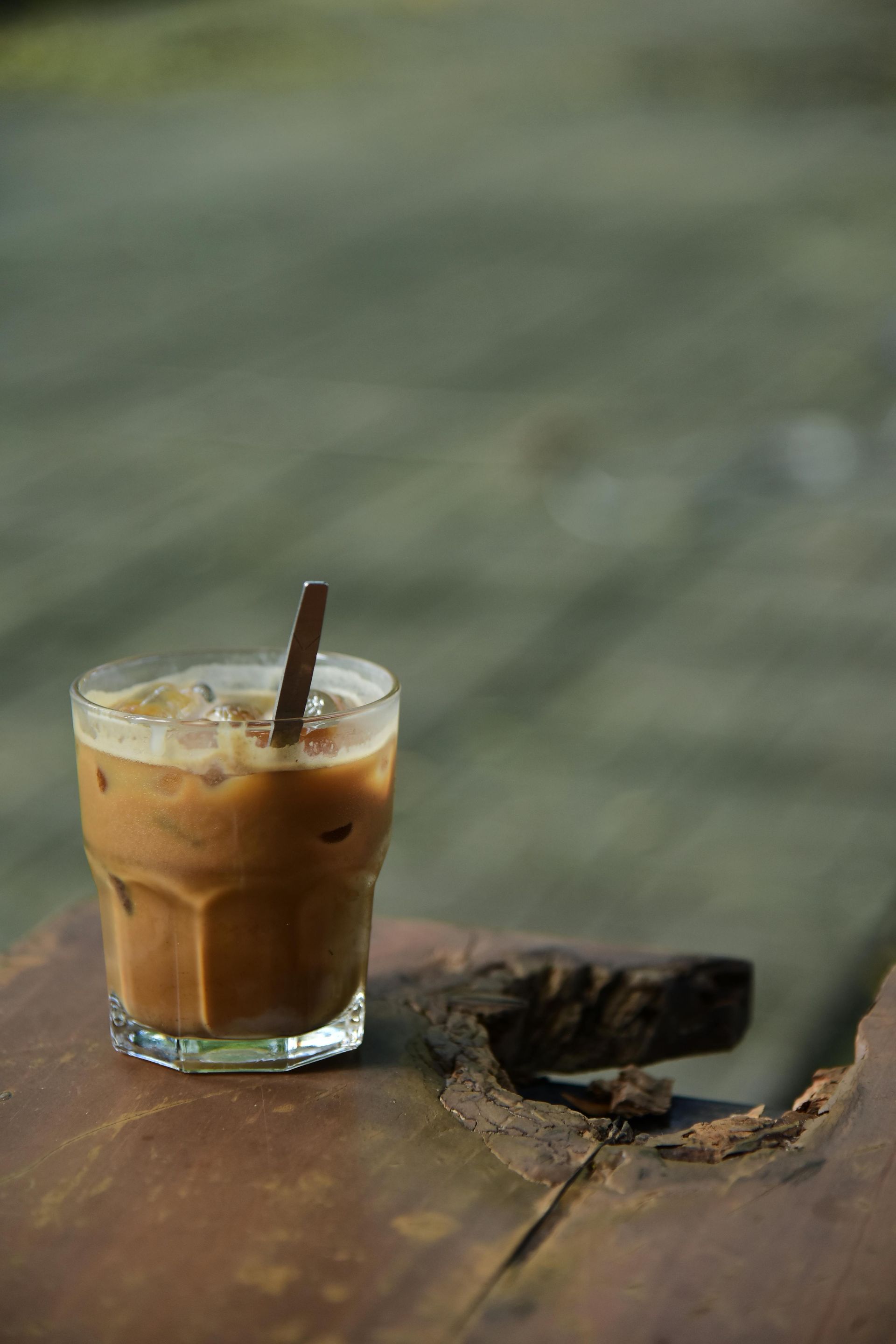 Coffee frappe with whipped cream, caramel drizzle, and a coffee bean.