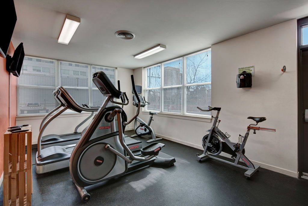 A gym with treadmills and exercise bikes in it
