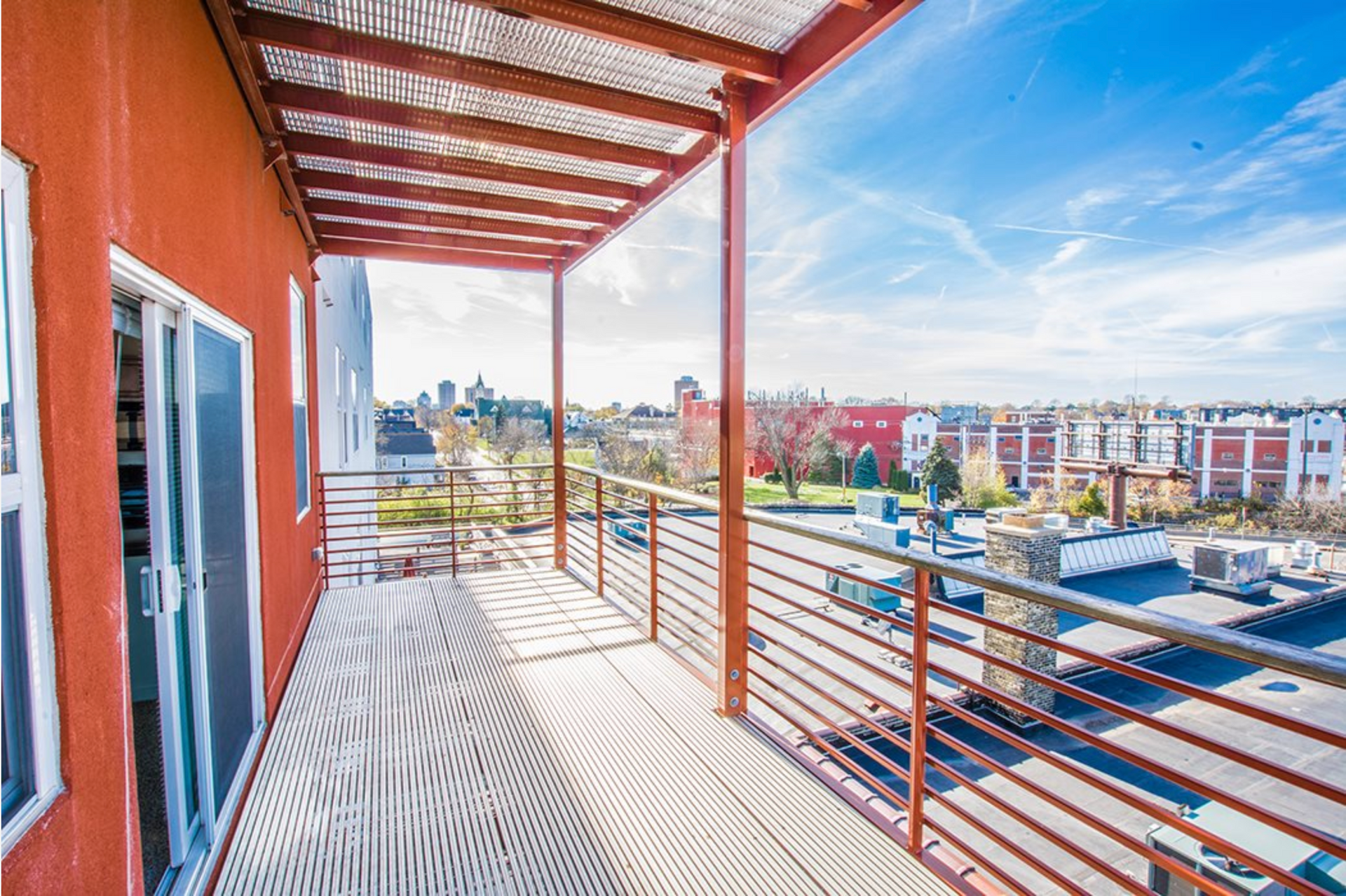 There is a balcony with a view of a city.