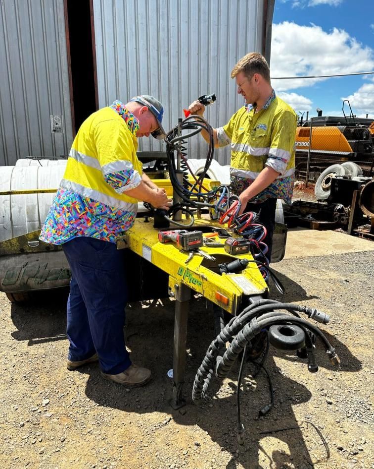Two Men Are Working on a Yellow Trailer — Trucks On The Run Pty Ltd in Southbrook, QLD