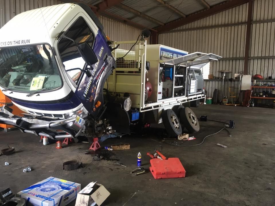 A truck is being repaired in a garage.