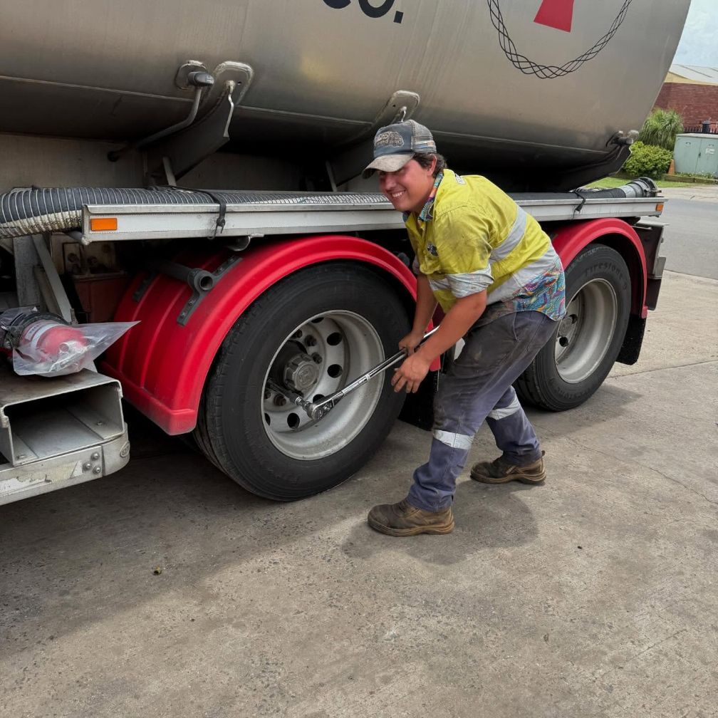 A Man in a Yellow Shirt is Working on a Truck — Trucks On The Run Pty Ltd in Wyreema, QLD