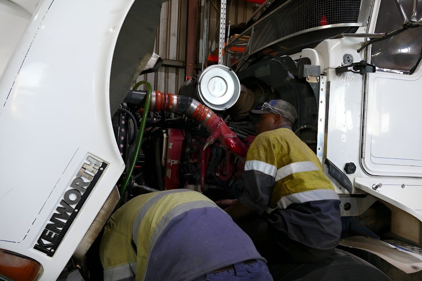 Two Men Are Working on a Kenworth Truck in a Garage — Trucks On The Run Pty Ltd in Gatton, QLD