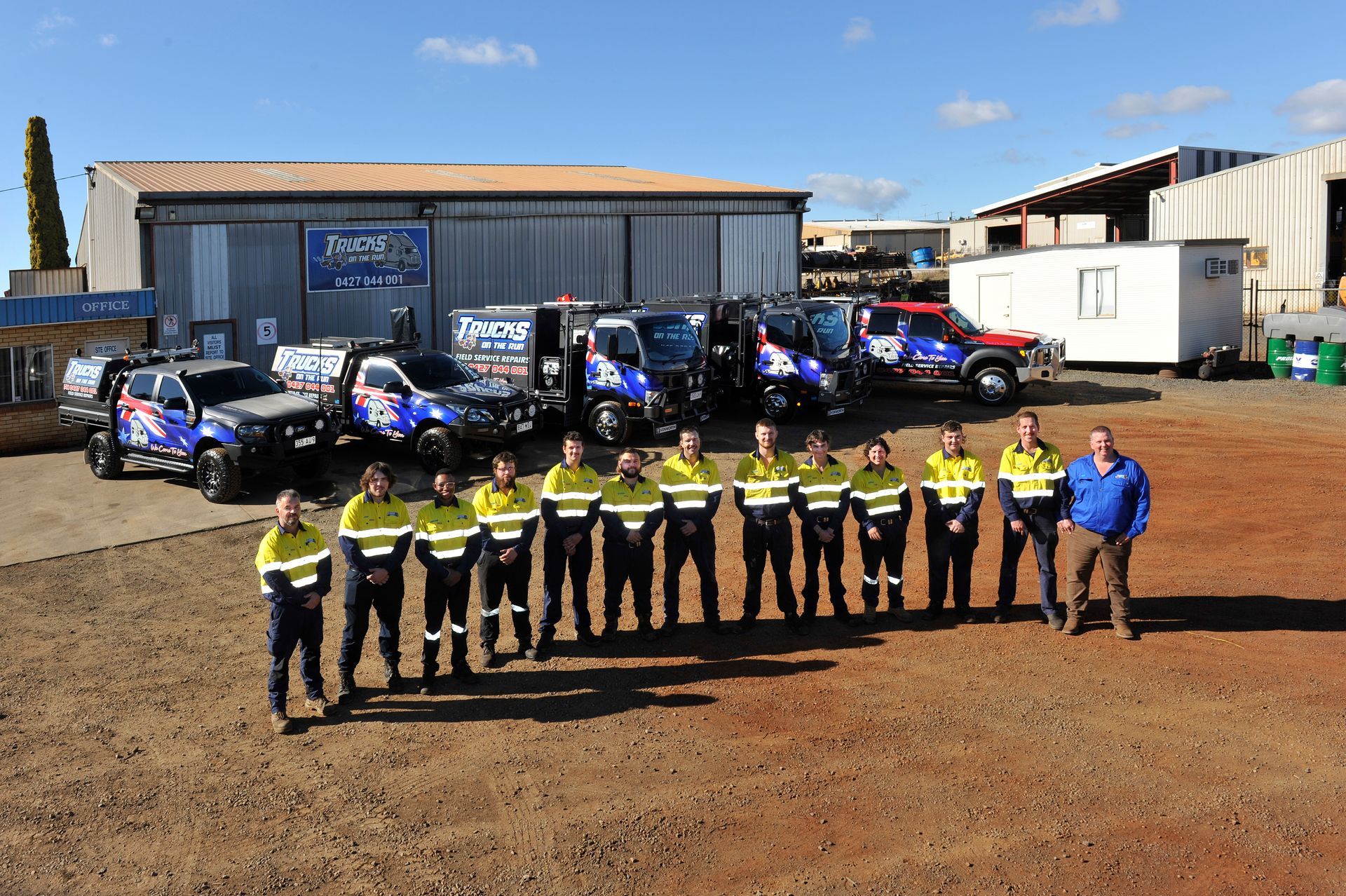 A Group of People Standing in Front of a Row of Trucks — Trucks On The Run Pty Ltd in Wilsonton, QLD