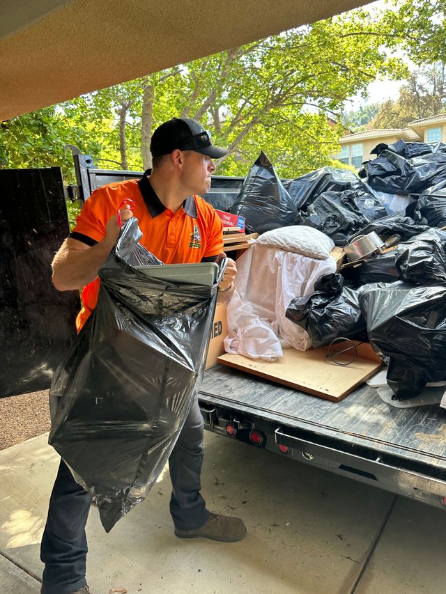 A man is loading a trailer into a truck.