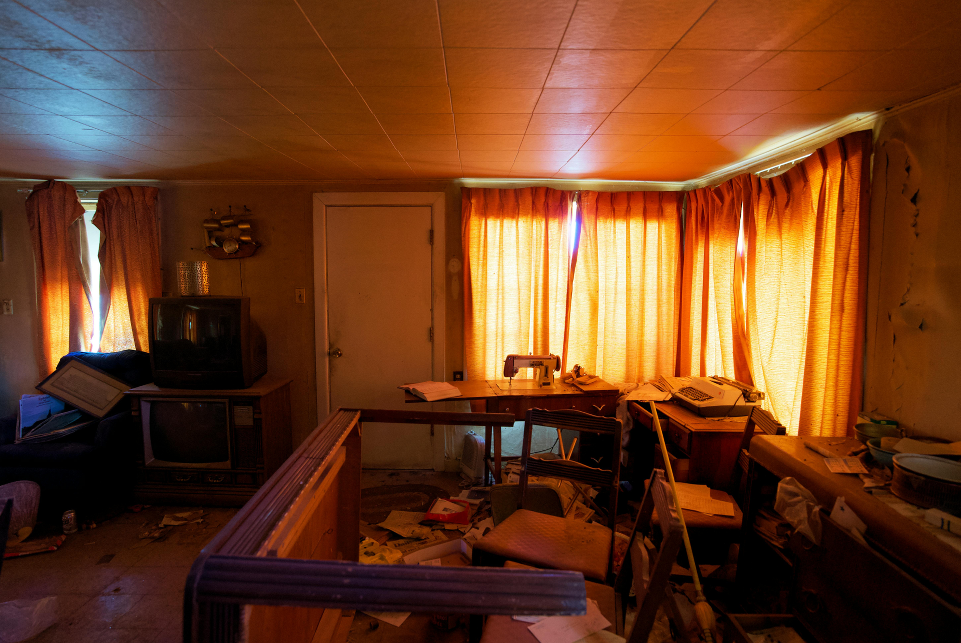A living room with a table , chairs , and a television.