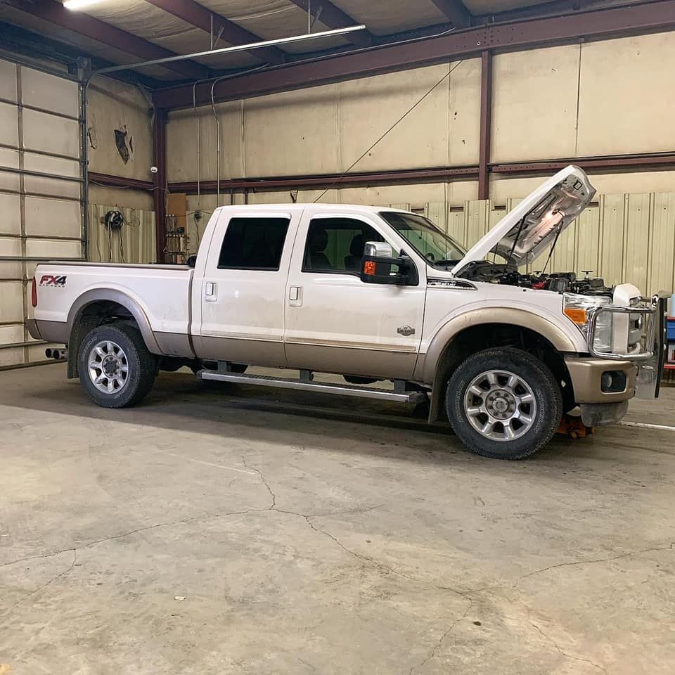 The Hood of a White Volkswagen Is Open for Engine Repair  | Jake's Automotive and Diesel Repair