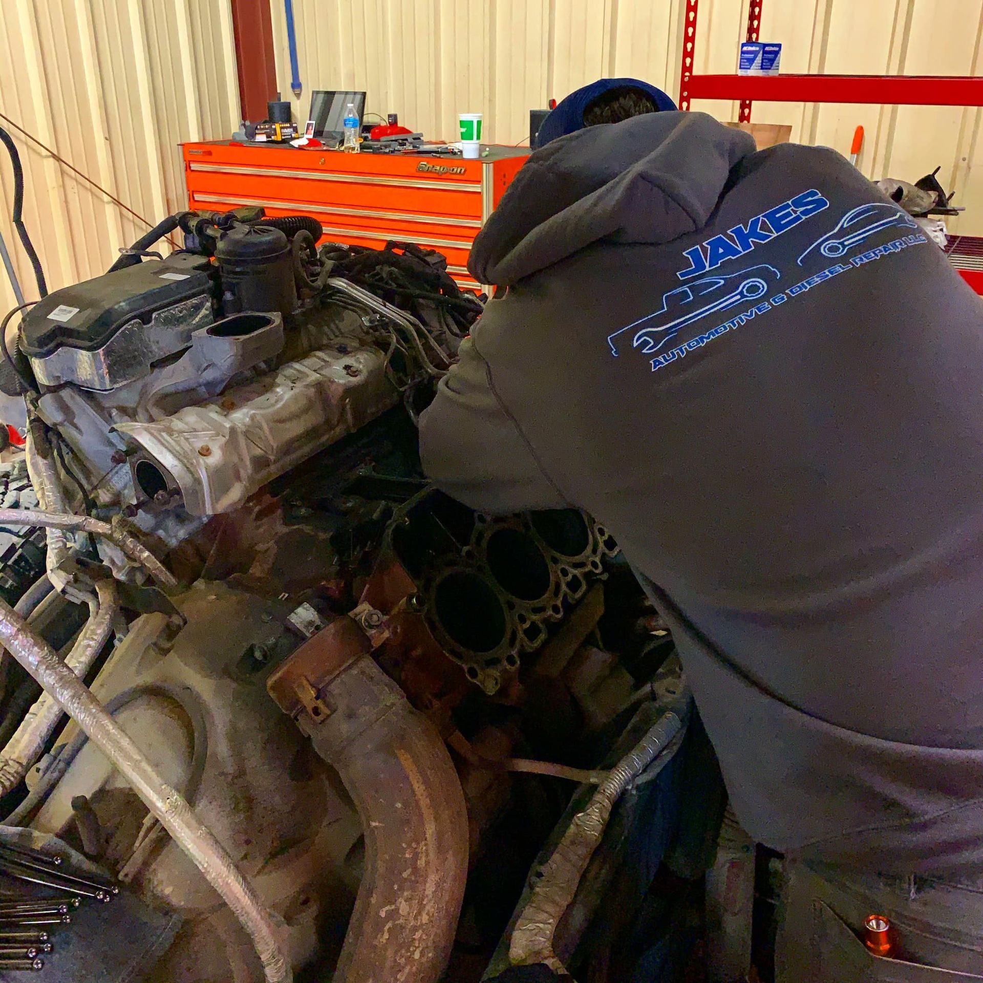 The Hood of a White Volkswagen Is Open for Engine Repair  | Jake's Automotive and Diesel Repair