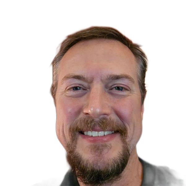 Man with a beard smiling, looking at the viewer.